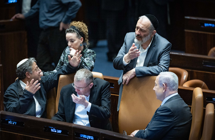 Justice Minister Yariv Levin sneezes amid a vote on the state bought at the assembly hall of the Knesset on December 6, 2023 (credit: YONATAN SINDEL/FLASH90)