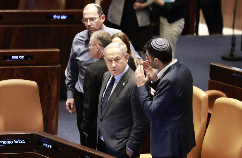 Prime Minister Benjamin Netanyahu seen in the Knesset plenum on December 6, 2023 (credit: MARC ISRAEL SELLEM)