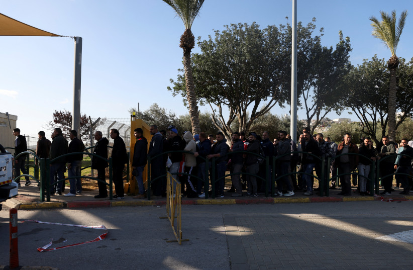  Palestinian workers wait to enter the settlement of Ma'ale Adumim, following a security incident, in the Israeli-occupied West Bank February 23, 2023. (credit: REUTERS/AMMAR AWAD)