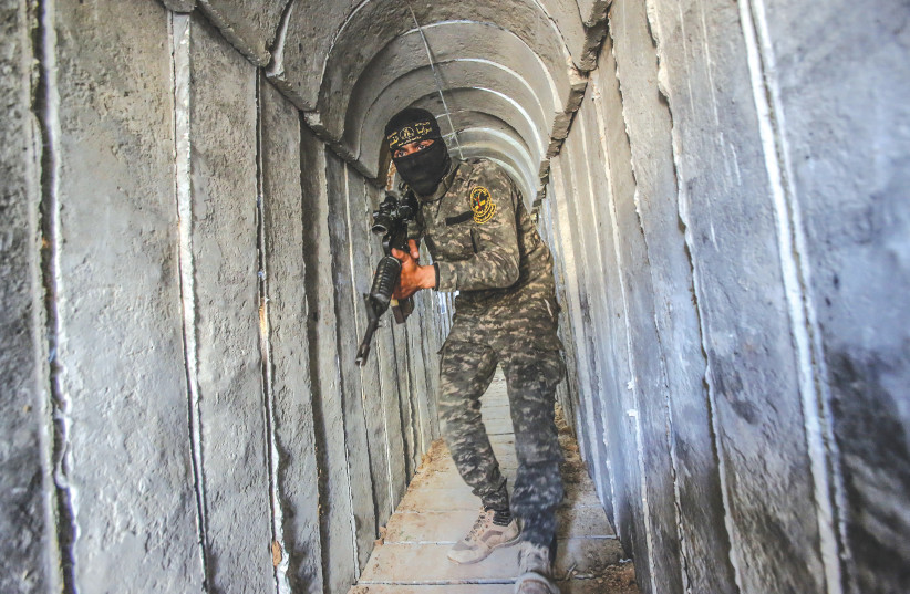  A terrorist from the al-Quds Brigades, the military wing of the Palestinian Islamic Jihad, is seen inside a military tunnel in Beit Hanun, in the Gaza Strip. (credit: ATTIA MUHAMMED/FLASH90)
