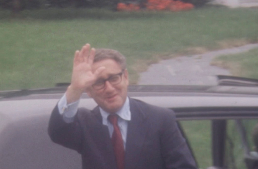 U.S. National Security Advisor Henry Kissinger waves to the press as he arrives for follow-up talks after the Paris Peace Accords on Vietnam with North Vietnamese Politburo member Le Duc Tho, in Saint-Nom-la-Breteche, near Paris, France, June 12, 1973 in this screengrab taken from a video.  (credit: REUTERS TV via REUTERS)