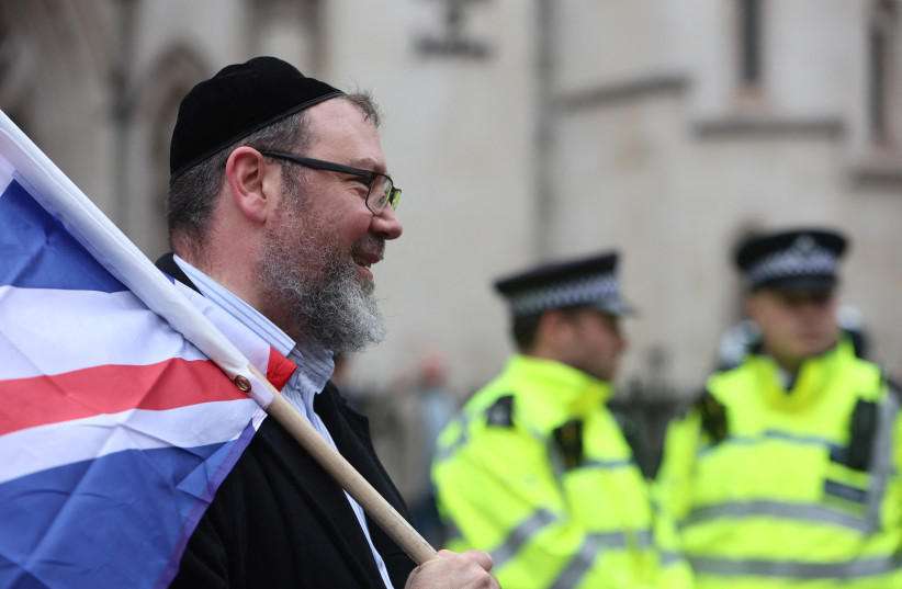 A man, wearing a kippah, holds the British flag at a march against antisemitism, after an increase in the UK, in London, Britain November 26, 2023.  (credit: REUTERS/Susannah Ireland)