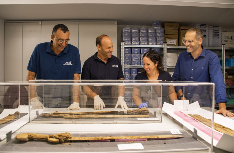  From right to left: Dr. Asaf Gayer, Oriya Amichay Dr. Eitan Klein and Amir Ganor with their findings (credit: YOLI SCHWARTZ/ISRAEL ANTIQUITIES AUTHORITY)