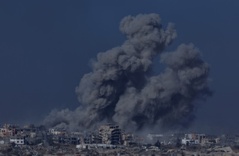  Smoke and debris rises over Gaza, amid the ongoing war between Israel and the Palestinian Islamist group Hamas, as seen from southern Israel, December 11, 2023. (credit: CLODAGH KILCOYNE/REUTERS)