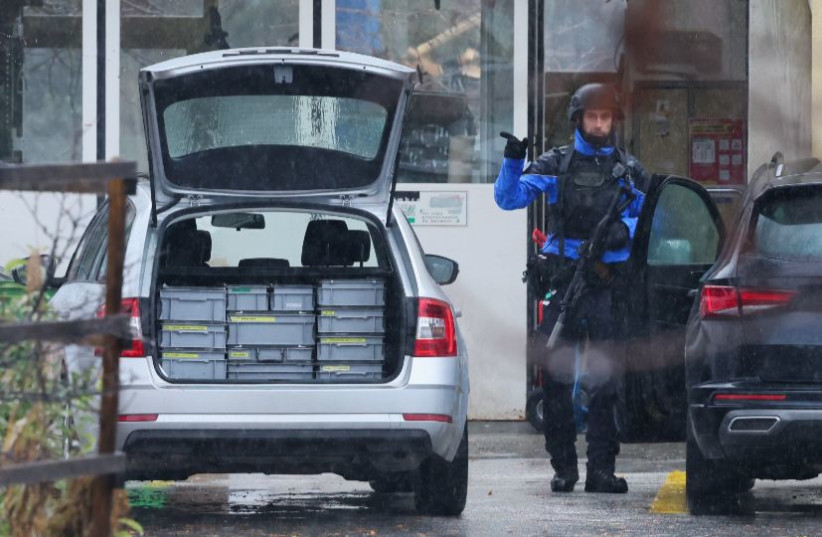 Police officer gestures at the site after a shooting in the Swiss town of Sion, Switzerland, December 11, 2023. (credit: DENIS BALIBOUSE/REUTERS)