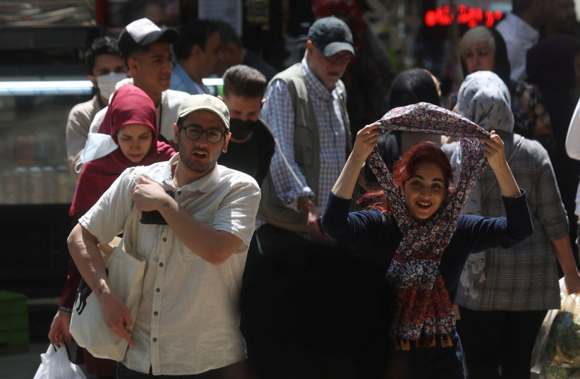 An Iranian woman walks on a street amid the implementation of the new hijab surveillance in Tehran, Iran, April 15, 2023.  (credit: Majid Asgaripour/WANA via Reuters)