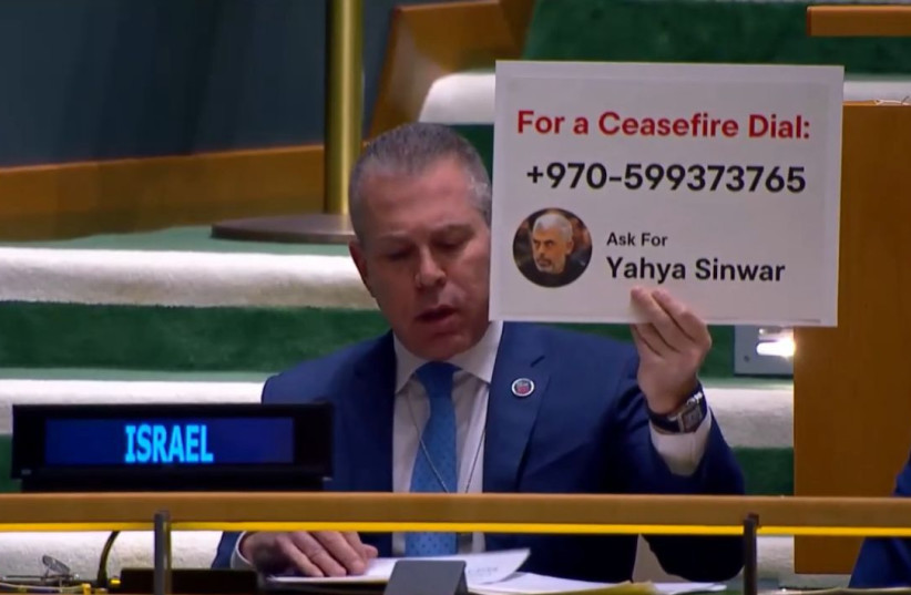 Israel's Ambassador to the UN Gilad Erdan held up a sign depicting Yahya Sinwar's office phone number at the UN. (credit: YOCHI COHEN)