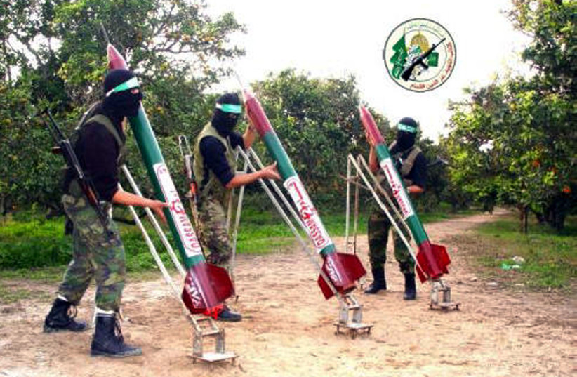  HAMAS MEMBERS pose with homemade Qassam rockets in a Gaza orchard, in the early 2000s. (credit: Hamas via Getty Images)