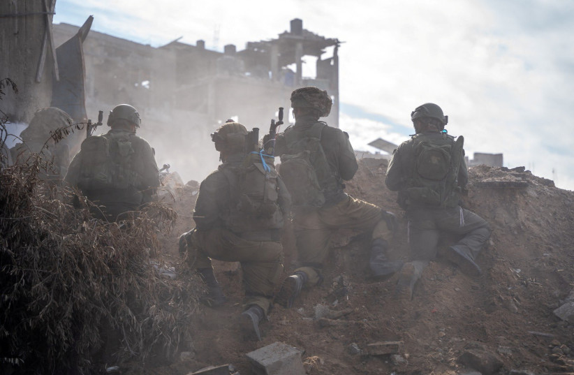  IDF soldiers operate in the Gaza Strip amid the ongoing conflict between Israel and the Palestinian Islamist group Hamas, in this handout picture released on December 17, 2023. (credit: IDF/Handout via REUTERS)