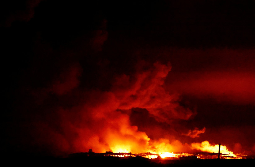  Fire burns in Gaza, amid the ongoing conflict between Israel and the Palestinian Islamist group Hamas, as seen from southern Israel, December 15, 2023.  (credit: CLODAGH KILCOYNE/REUTERS)