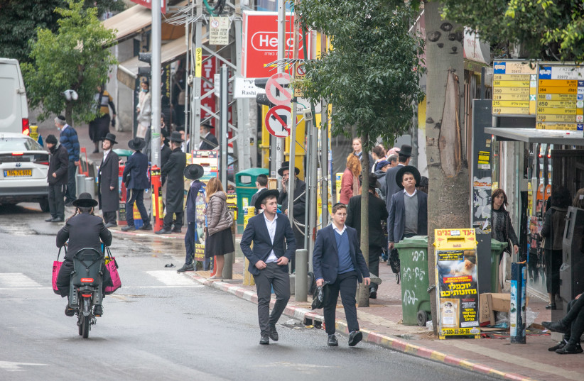 Ultra Orthodox Jews walk in the Ultra orthodox town of Bnei Brak on December 29, 2021.