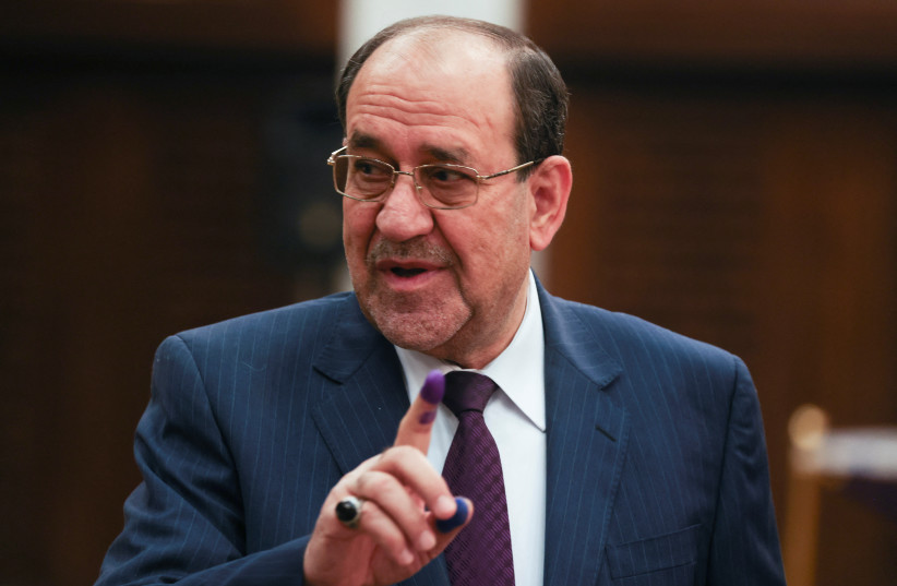 Former Iraqi Prime Minister Nouri al-Maliki shows his inked finger after casting his vote during Iraq's provincial council elections, at a polling station in Baghdad, Iraq, December 18, 2023.