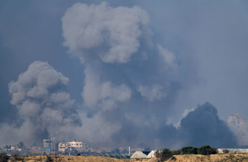  Smoke rises in the Gaza Strip, amid the ongoing conflict between Israel and the Palestinian Islamist group Hamas, as seen from southern Israel, December 19, 2023.  (credit: CLODAGH KILCOYNE/REUTERS)