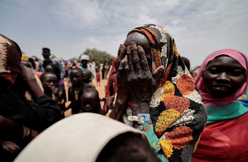  A Sudanese woman, mourns her son and a relative, who according to her were killed by Rapid Support Forces (RSF), in Ourang on the outskirts of Adre, Chad July 25, 2023 (credit: REUTERS/ZOHRA BENSEMRA)