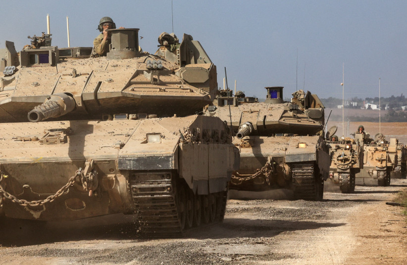   Israeli tanks and military vehicles take position near Israel's border with the Gaza Strip, in southern Israel, October 13, 2023 (credit: REUTERS/VIOLETA SANTOS MOURA)