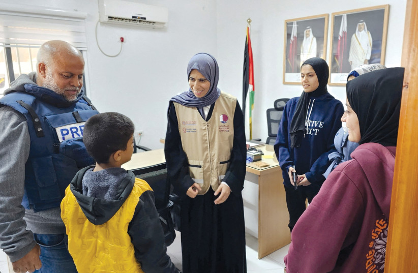  Qatari Minister of State for International Cooperation Lolwah Bint Rashid Al Khater talks to a Palestinian boy as she visits Gaza during a temporary truce between Israel and Hamas on November 26. (credit: Qatar’s Ministry of Foreign Affairs/Reuters)