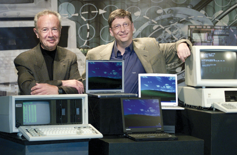  Bill Gates poses for photographers with Andy Grove, then-chairman of Intel Corporation, at the Tech Museum of Innovation in San Jose, California, in 2001, next to two of the oldest computers at each end and three of the newest laptop computers in the center. (credit: REUTERS)