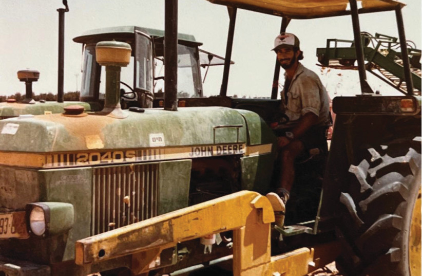  BENJY HARVESTS onions on a tractor at Kibbutz Lotan, 1980s. (credit: Maor family)