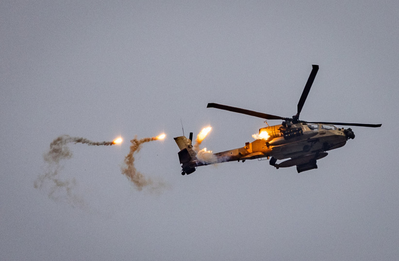  An Israeli combat helicopter shoots flares above the Israeli border with the Gaza Strip, December 21, 2023. (credit: Chaim Goldberg/Flash90)