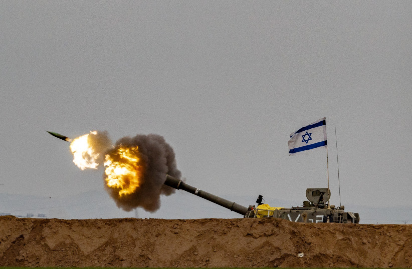 Israeli artillery unit firing shells towards the Gaza Strip near the Israeli-Gaza border, in southern Israel, December 21, 2023.