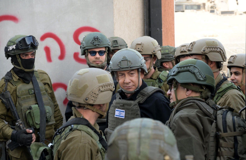  Prime Minister Benjamin Netanyahu meets IDF reservists in the Gaza Strip on December 25, 2023  (credit: IDF SPOKESPERSON'S UNIT)