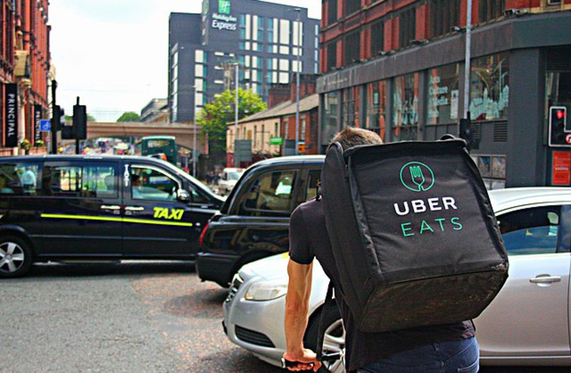  Uber Eats delivery cyclist rides through Manchester. (credit: SHOPBLOCKS / CC 2.0 www.shopblocks.com/pages/restaurant-websites)