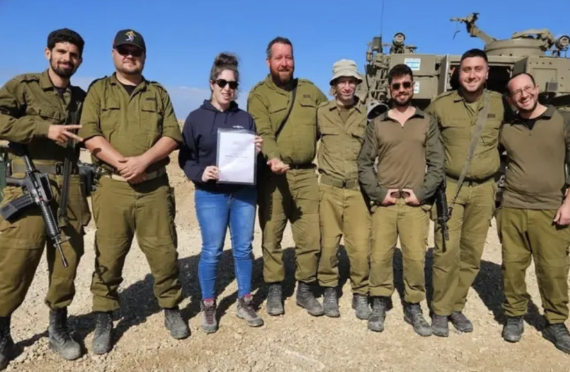  Soldiers are presented with a certificate to mark their discovery. (credit: ISRAEL ANTIQUITIES AUTHORITY.)