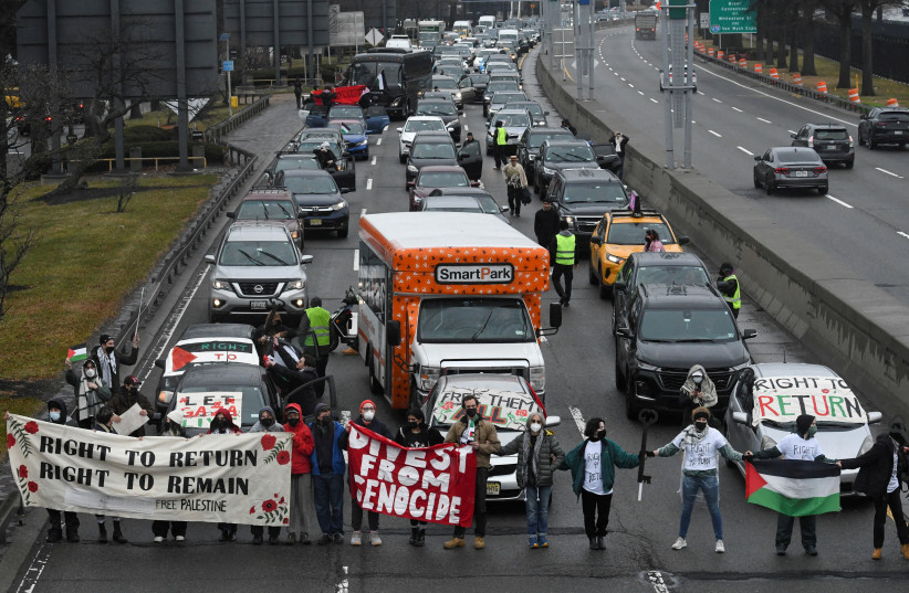 Pro-Palestinian demonstrators block traffic on the road that leads to John F Kennedy airport (JFK), amid the ongoing conflict between Israel and the Palestinian terrorist group Hamas, in New York City, US. December 27, 2023. (credit: REUTERS/STEPHANIE KEITH)