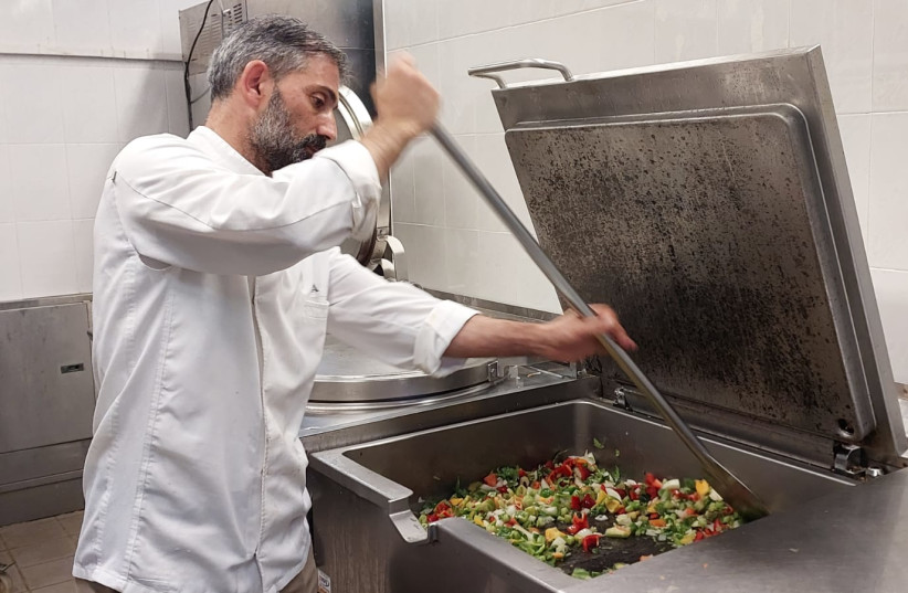  Head Chef Khalil Adila prepares dinner for displaced Israelis, (credit: Lana Ikelan/The Media Line)