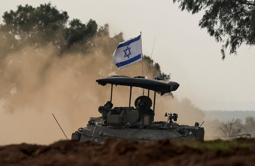 Israeli soldiers ride a military vehicle, in southern Israel, December 28, 2023