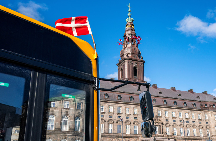 Flags flutter on the Christiansborg Palace People in Copenhagen, Denmark (credit: RITZAU SCANPIX/NIELS CHRISTIAN VILMANN VIA REUTERS)