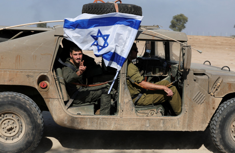 Israeli soldiers sit inside a military vehicle near the Israel-Gaza border, in southern Israel, December 31, 2023 (credit: FLASH90)