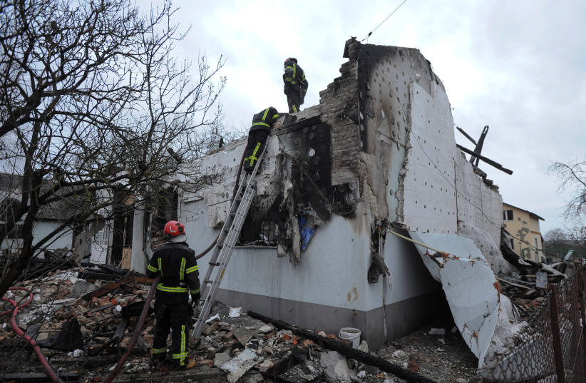  Firefighters work at the site of a museum dedicated to Roman Shukhevych, leader of the Ukrainian Insurgent Army (UPA), which was destroyed by a Russian drone strike, amid Russia's attack on Ukraine, in Lviv, Ukraine January 1, 2024.  (credit: REUTERS/Mykola Tys)