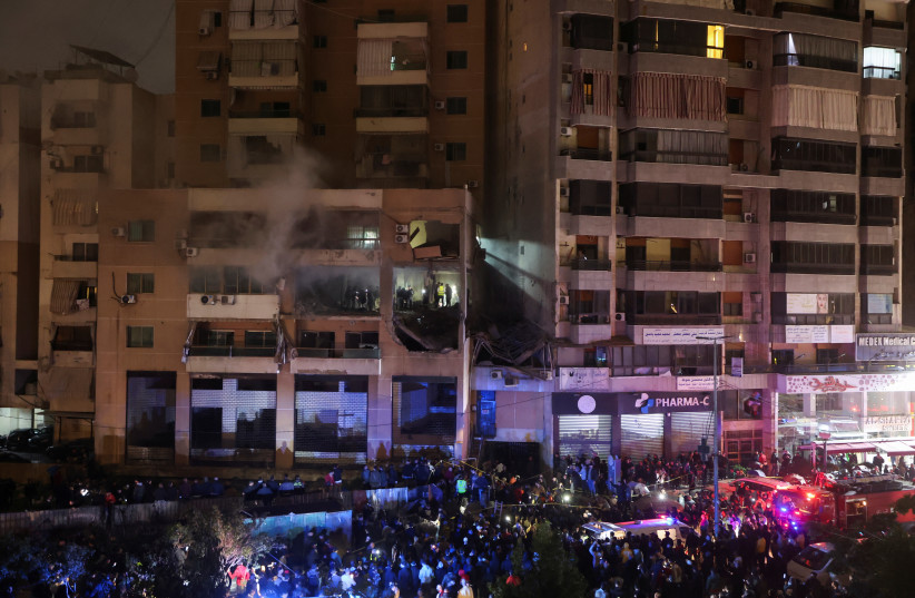 People gather near a damaged site following an explosion at the Beirut suburb of Dahiyeh, Lebanon January 2, 2024. (credit: REUTERS/MOHAMED AZAKIR)