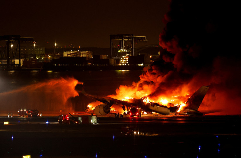  Firefighters work at Haneda International Airport after Japan Airlines' A350 airplane caught on fire, in Tokyo, Japan January 2, 2024. (credit: REUTERS/ISSEI KATO)