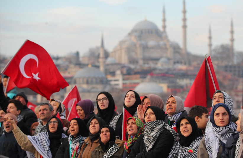  People gather over the Galata Bridge in solidarity with Palestinians, amid the ongoing conflict between Israel and Hamas, following the first morning prayer of the New Year in Istanbul, Turkey January 1, 2024 (credit: REUTERS/DILARA SENKAYA)