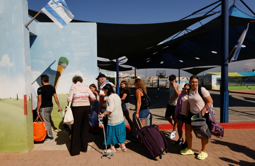 People queue as Israelis are evacuated from the southern town of Sderot, near Israel's border with Gaza, October 15, 2023.   (credit: REUTERS/AMIR COHEN)