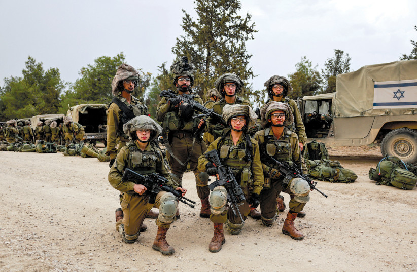  IDF soldiers pose for a photograph near the border with Gaza on December 12, 2023. (credit: AMMAR AWAD/REUTERS)