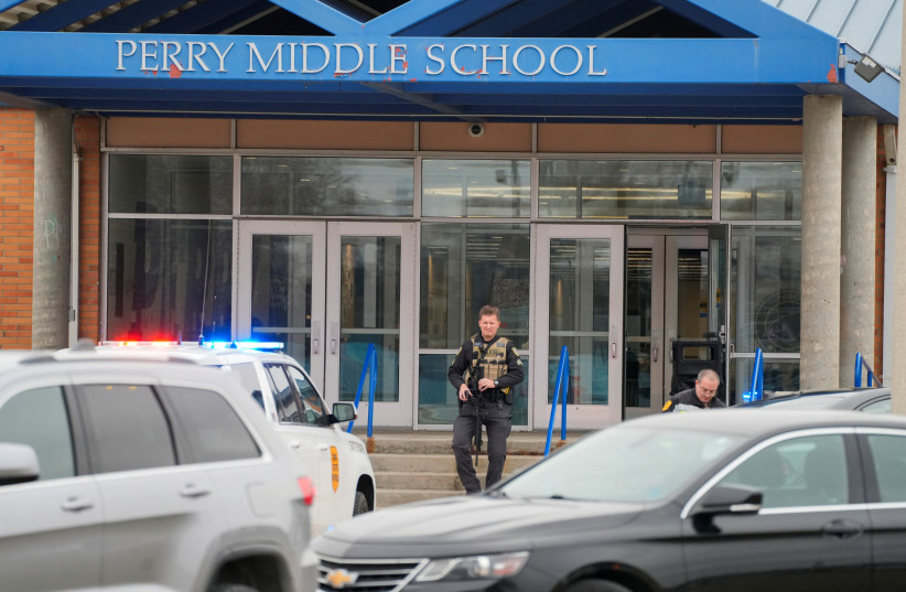  Law enforcement officers work at the scene of a shooting at Perry High School in Perry, Iowa, US, January 4, 2024 (credit: REUTERS/SCOTT MORGAN)