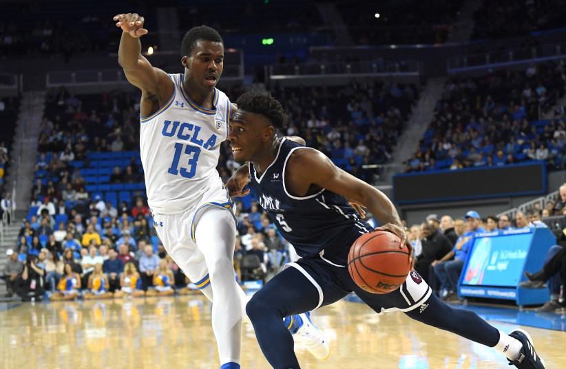  UCLA Bruins guard Kris Wilkes (13) guards Loyola Marymount Lions guard James Batemon (5) as he drives to the basket in the second half of the game at Pauley Pavilion. (credit: JAYNE KAMIN-ONCEA-USA TODAY SPORTS/REUTERS)