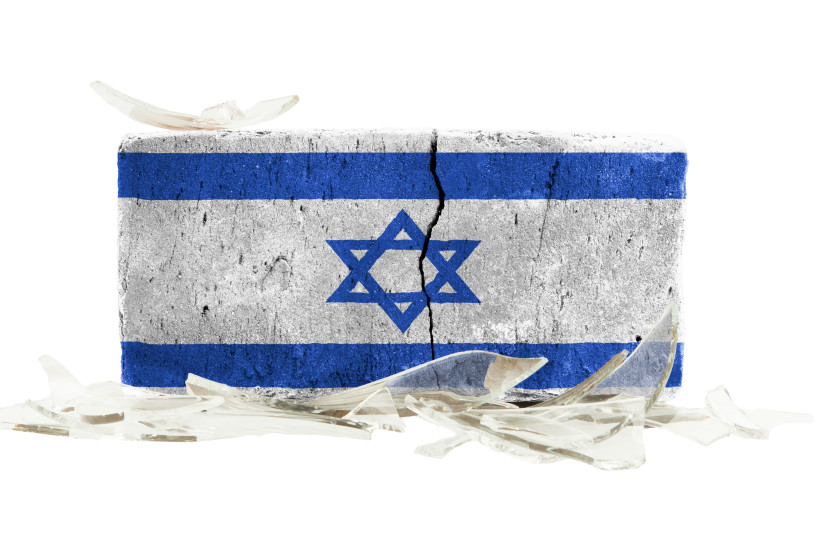 After a few years working in the news and seeing crises unfold, my idealistic view of Israel has been shattered. Pictured: Illustrative image of a cracked Israeli flag brick surrounded by shattered glass. (credit: INGIMAGE)