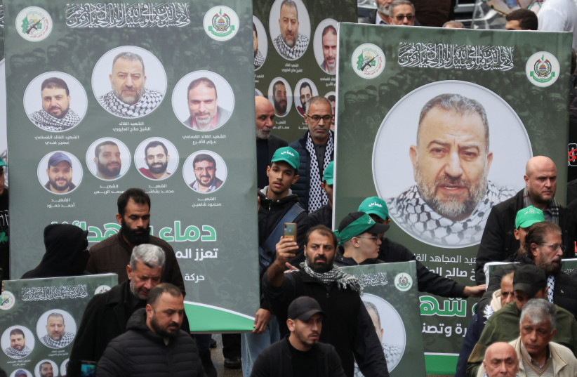    People carry placards with pictures of deputy head of Hamas, Saleh al-Arouri, who was killed by what Lebanese and Palestinian security sources say was a drone strike by Israel, as mourners gather during his funeral in Beirut, Lebanon January 4, 2024.  (credit: REUTERS/MOHAMED AZAKIR)
