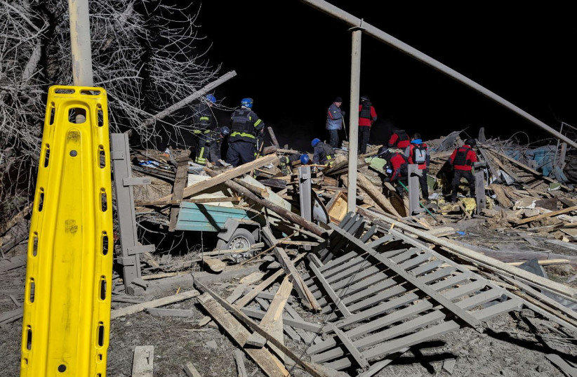 Rescuers work at the site of a Russian missile strike in an area of the Pokrovsk town, amid Russia's attack on Ukraine, in Donetsk region, Ukraine January 6, 2024 (credit: VIA REUTERS)