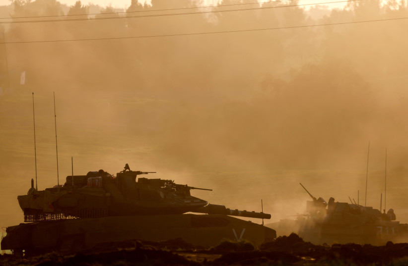 Israeli tank and APC maneuver along the border fence on the Israeli side of the border with Central Gaza, amid the ongoing conflict between Israel and the Palestinian terrorist group Hamas, in Israel, January 6, 2024. (credit: AMIR COHEN/REUTERS)