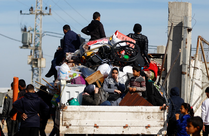  Displaced Palestinians, who fled their houses due to Israeli strikes, ride a vehicle in Rafah in the southern Gaza Strip, January 8, 2024 (credit: REUTERS/IBRAHEEM ABU MUSTAFA)