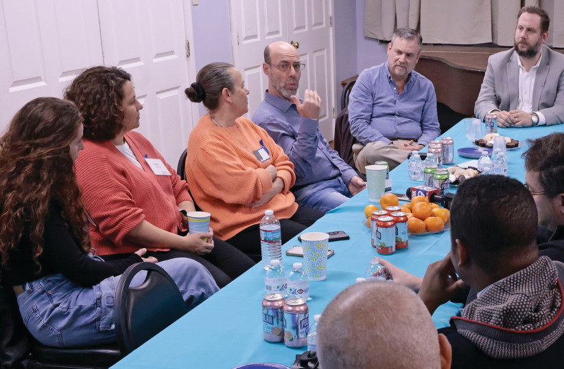  SURVIVORS OF THE Oct. 7 attack on Israel: Hila Fakliro, left, Shani Teshuva, Rony Kissin and her husband, Ofer Kissin, share their stories of survival with the group at the Kaiserman JCC in Wynnewood, Pennsylvania. (credit: Elizabeth Robertson/The Philadelphia Inquirer/TNS)