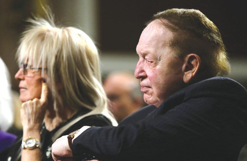 MIRIAM AND the late Sheldon Adelson listen to Nobel Peace laureate Elie Wiesel (not pictured) at a roundtable discussion on Capitol Hill in Washington, in 2015. (credit: GARY CAMERON/REUTERS)