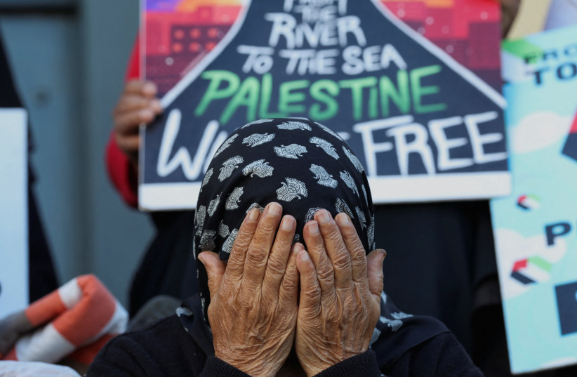  A woman reacts during an interfaith prayer service in Bo-Kaap for the success of the South African Government's genocide case, which accuses Israel of genocide in the Gaza war, at the International Court of Justice in the Hague, in Cape Town, South Africa, January 10, 2024 (credit: REUTERS/ESA ALEXANDER)