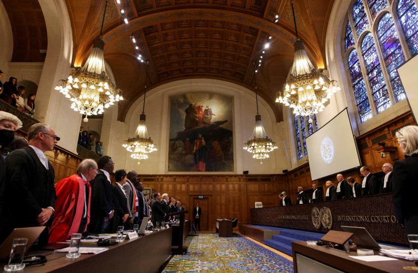 People stand inside the International Court of Justice (ICJ) as judges hear a request for emergency measures to order Israel to stop its military actions in Gaza, in The Hague, Netherlands January 12, 2024. (credit: REUTERS/THILO SCHMUELGEN)