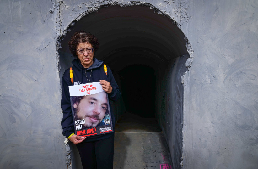  Families of Israelis held hostage by Hamas terrorists in Gaza standing outside a tunnel installation at Hostages Square in Tel Aviv on January 13, 2024 (credit: TOMER NEUBERG/FLASH90)